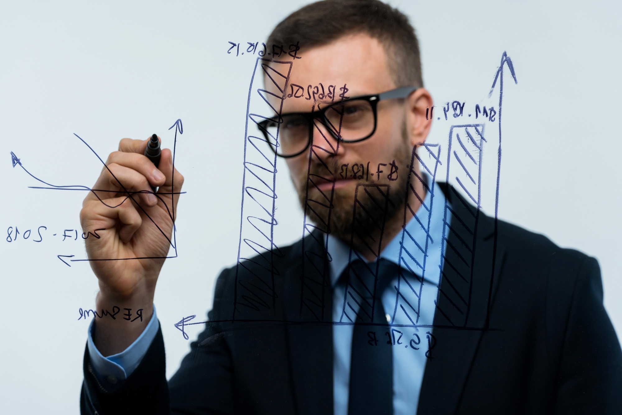 Man draws various growth charts, calculating prospects for succe